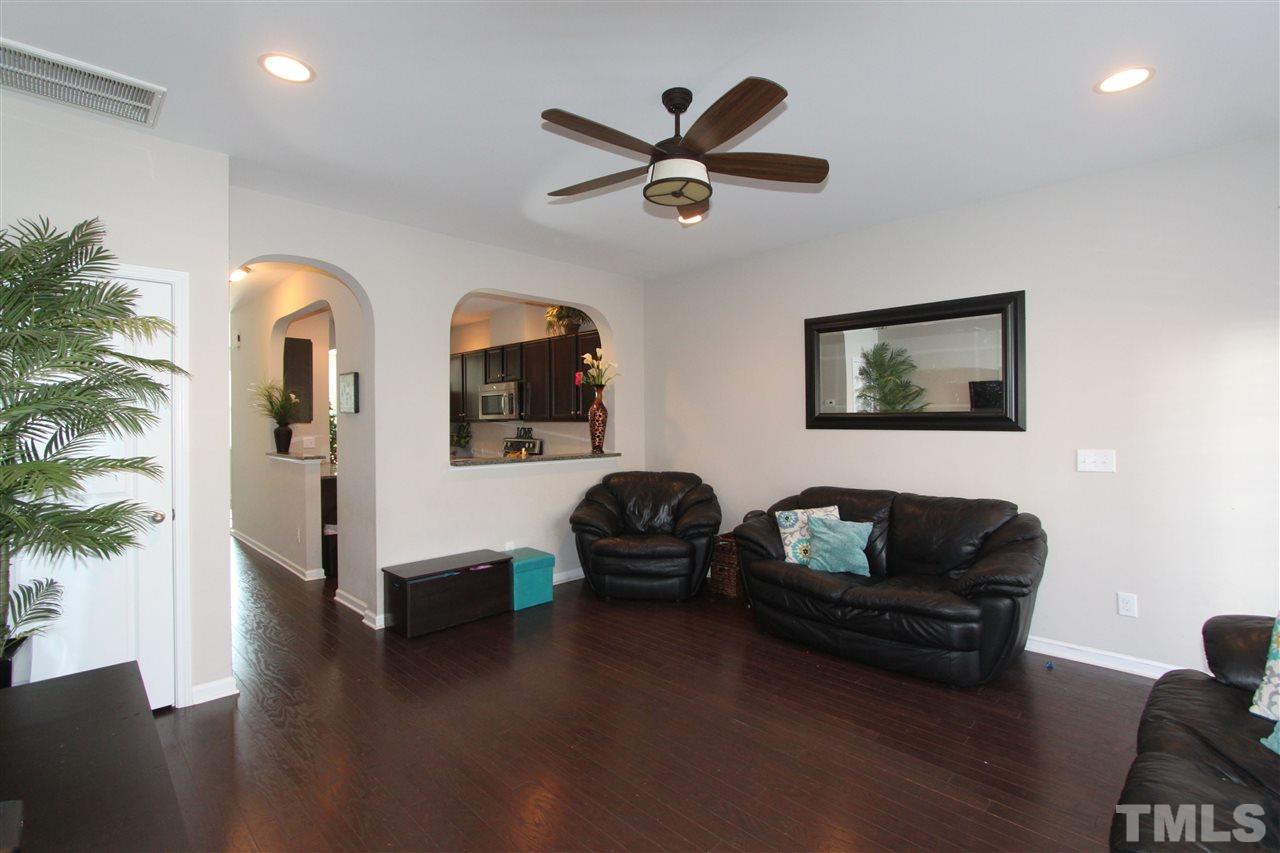 760 Wickham Ridge Road Apex, NC 27539 - Photo 10 of 25 a living room with furniture and a wooden floor