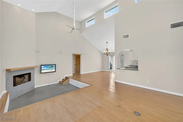 a view of a livingroom with wooden floor and a ceiling fan