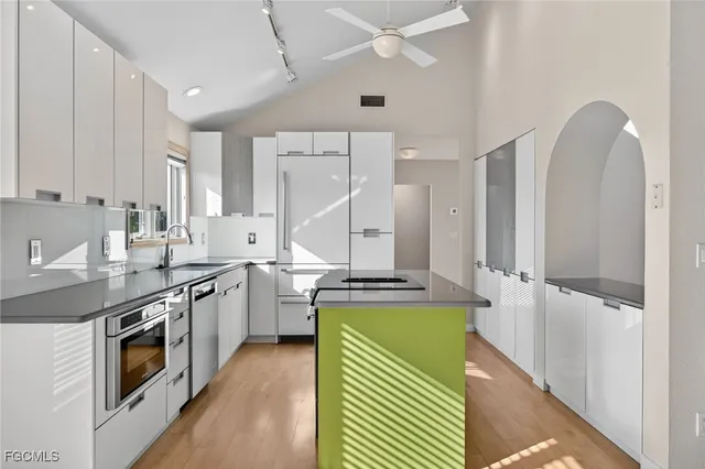 a kitchen with a sink stove and cabinets