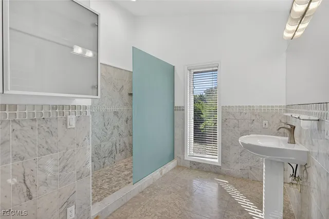 a bathroom with a sink a shower and a mirror