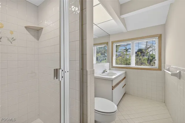 a bathroom with a toilet a sink and a shower