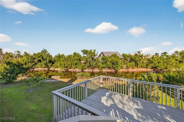 a view of a balcony with wooden floor & fence
