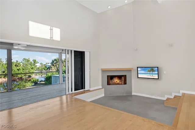 a view of a hallway with a fireplace and a large window