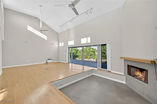 a view of an empty room with a fireplace and a window