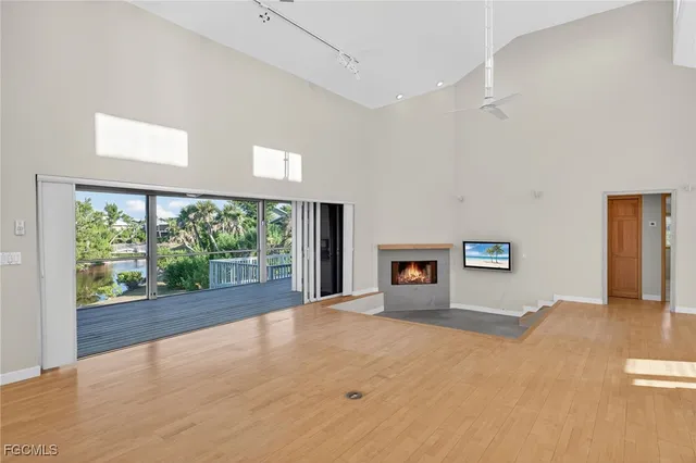 a view of a big room with wooden floor and windows