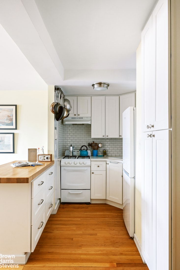 39-76 57th Street, Unit 4G Queens, NY 11377 - Photo 3 of 8 a kitchen with a sink cabinets and window