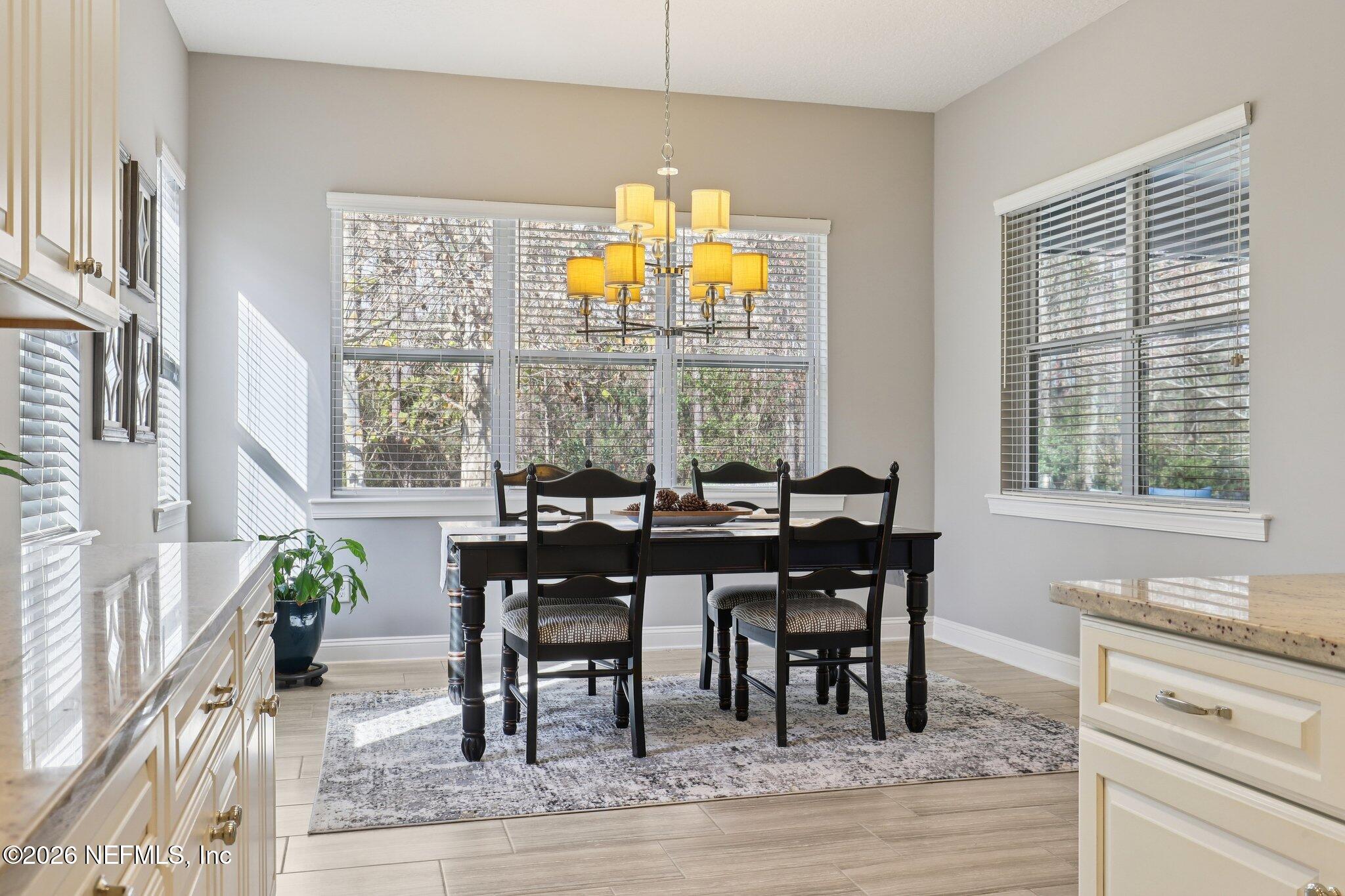 147 Dock House Road St. Johns, FL 32259 - Photo 13 of 67 a view of a dining room with furniture a chandelier and wooden floor