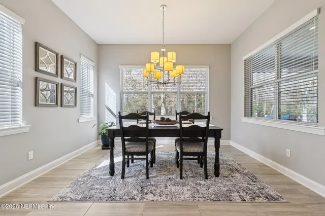 a bathroom with a sink a toilet and shower curtain