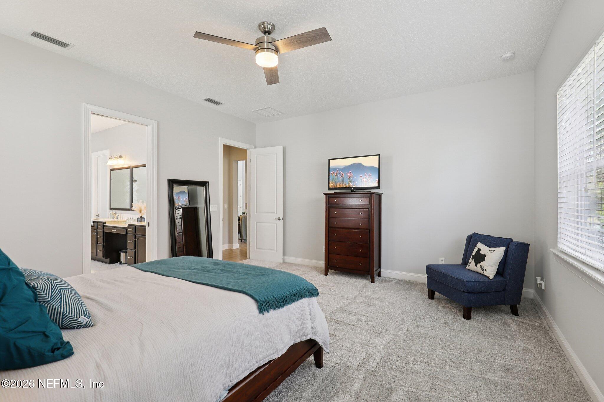 147 Dock House Road St. Johns, FL 32259 - Photo 28 of 67 a spacious bedroom with a bed and a chandelier