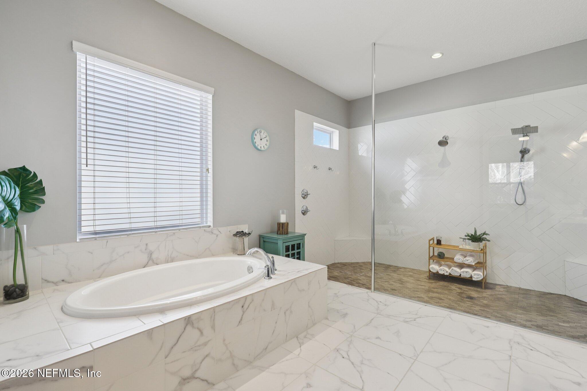 147 Dock House Road St. Johns, FL 32259 - Photo 31 of 67 a spacious bathroom with a tub shower and window