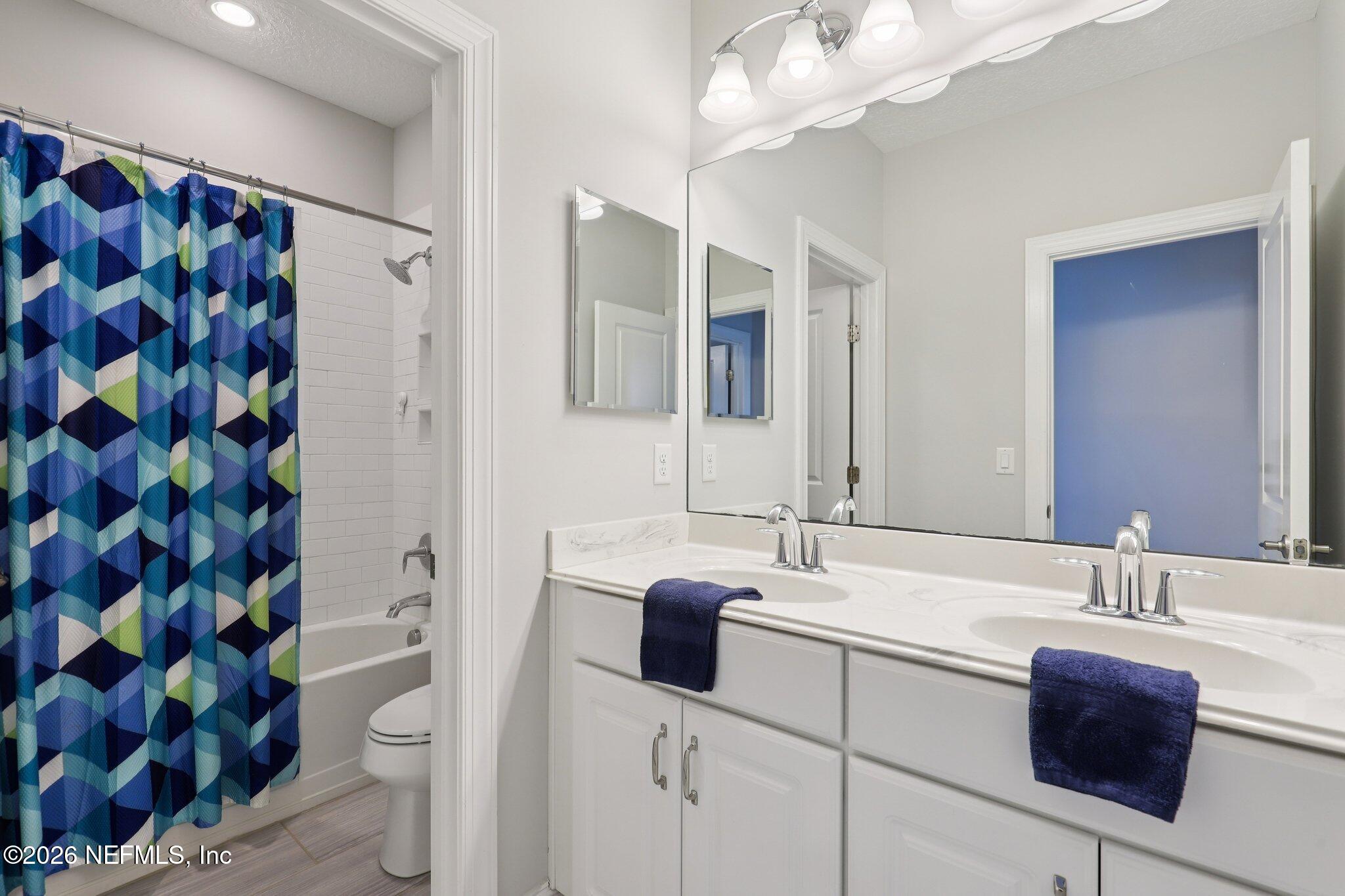 147 Dock House Road St. Johns, FL 32259 - Photo 45 of 67 a bathroom with a sink a toilet and shower curtain