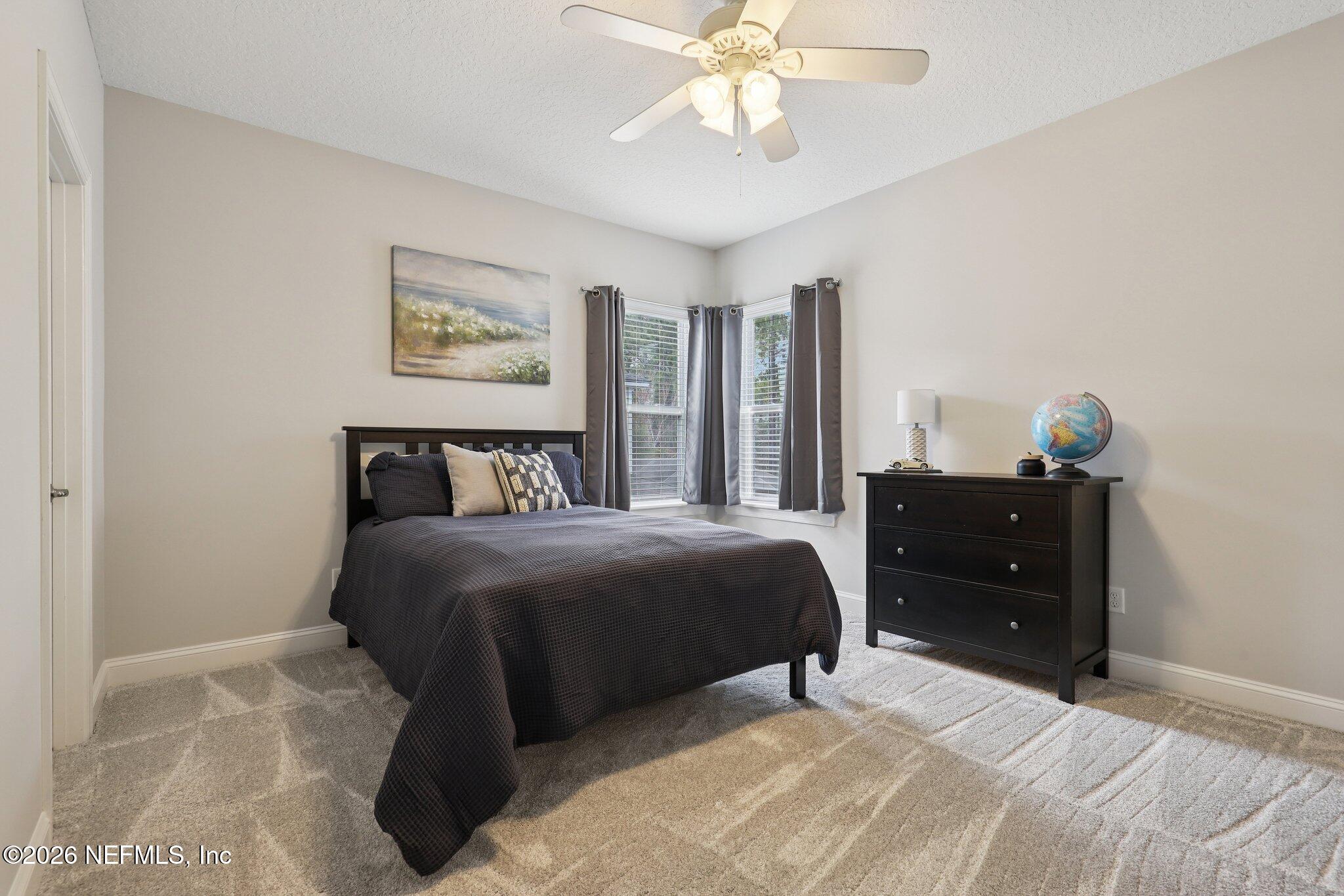 147 Dock House Road St. Johns, FL 32259 - Photo 46 of 67 a bedroom with a bed and a chandelier