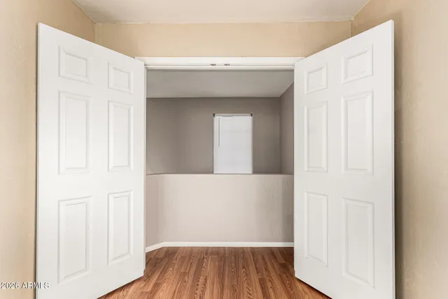a view of a hallway with wooden floor