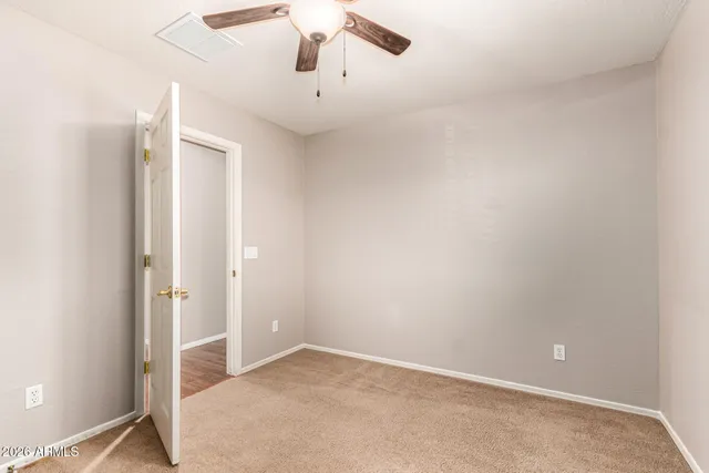 an empty room with a empty space and a ceiling fan