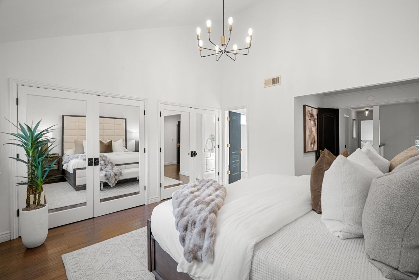 1147 Longshore Drive San Jose, CA 95128 - Photo 13 of 28 a bedroom with a large bed and a chandelier