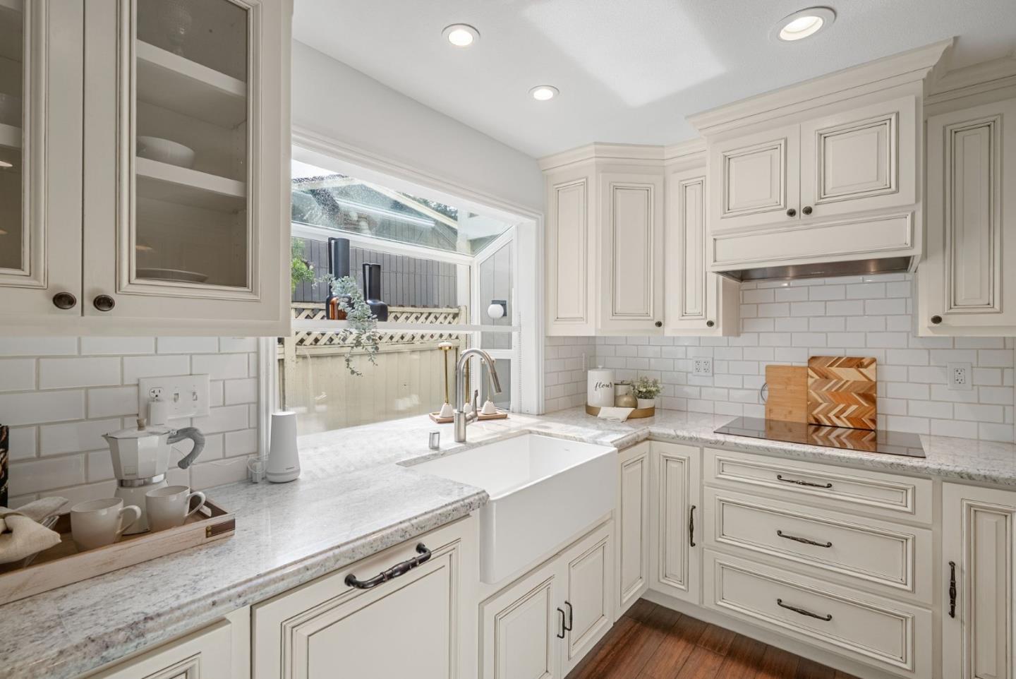 1147 Longshore Drive San Jose, CA 95128 - Photo 5 of 28 a kitchen with white cabinets and sink