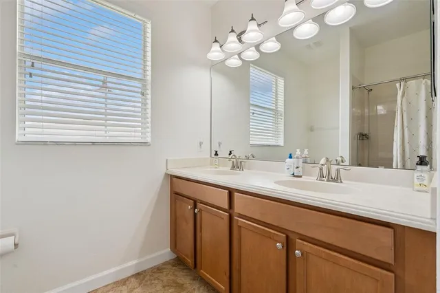 a kitchen with stainless steel appliances granite countertop a sink a stove and a wooden floors