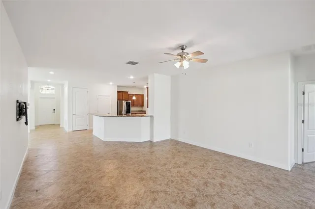 a view of a white house with a swimming pool and a yard