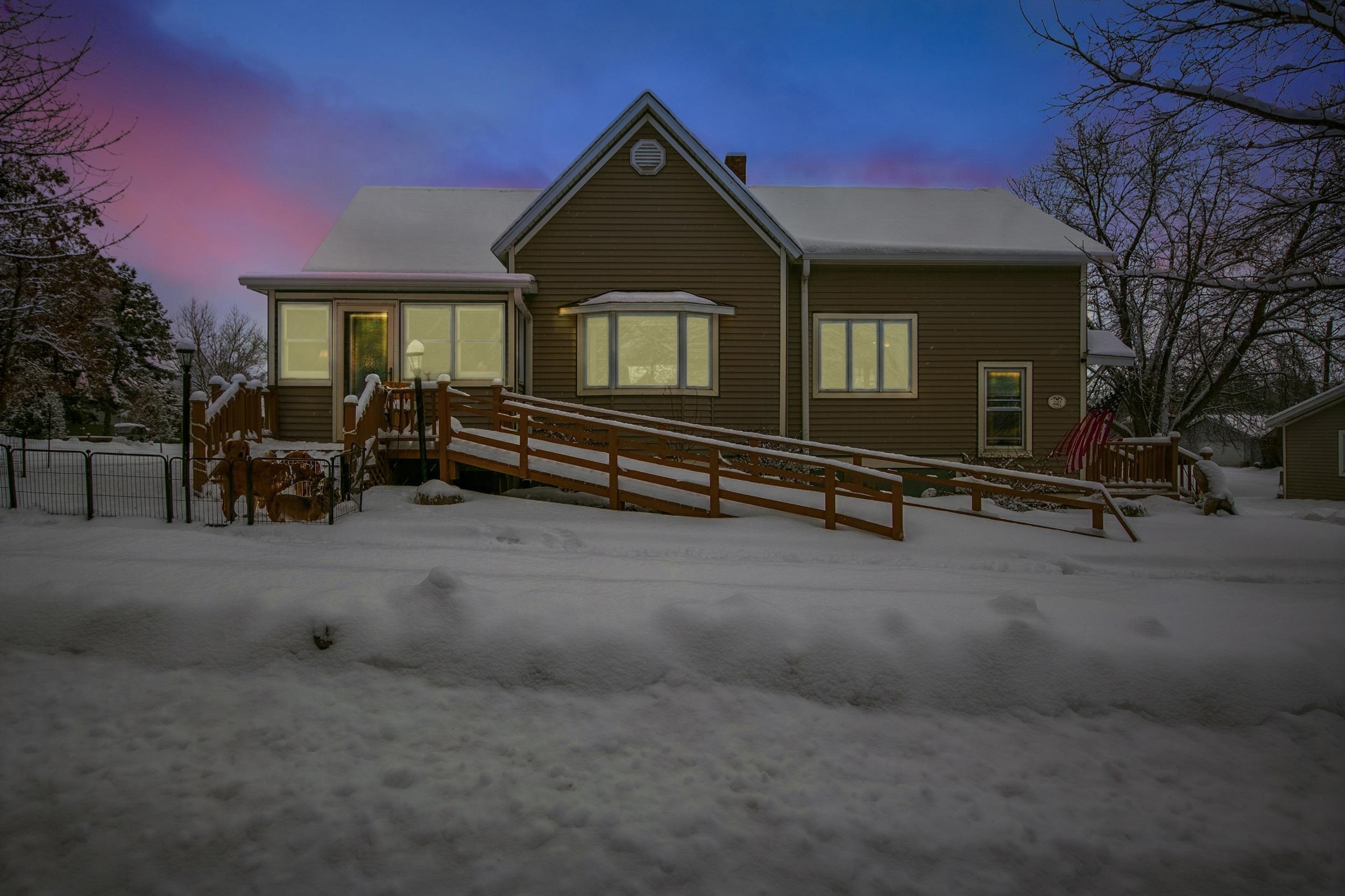 220 5th Avenue West Washburn, WI 54891 - Photo 1 of 38 View of front facade with a wooden deck and a chimney
