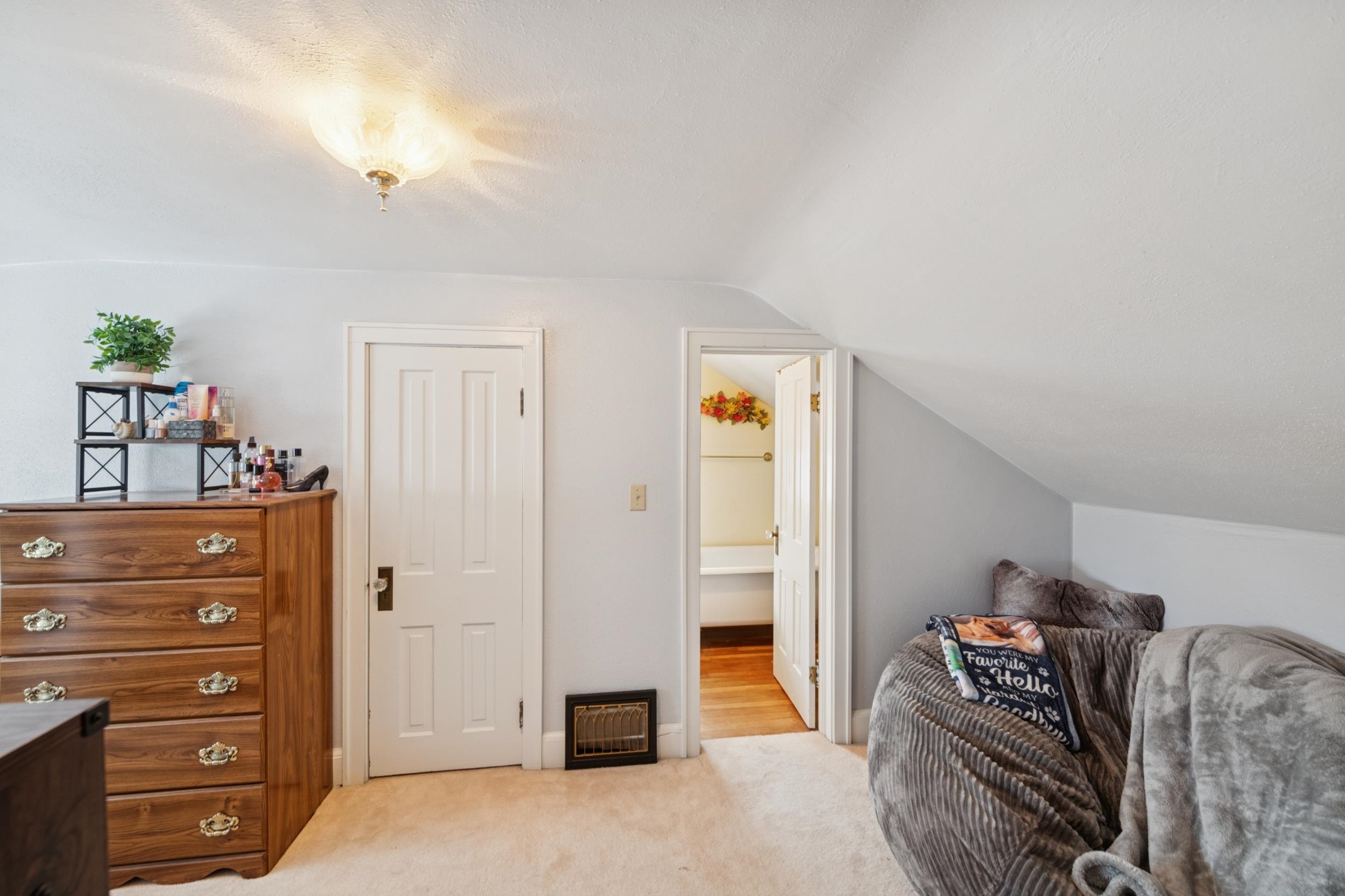 220 5th Avenue West Washburn, WI 54891 - Photo 17 of 38 Bedroom with ensuite bath, light colored carpet, lofted ceiling, and a closet