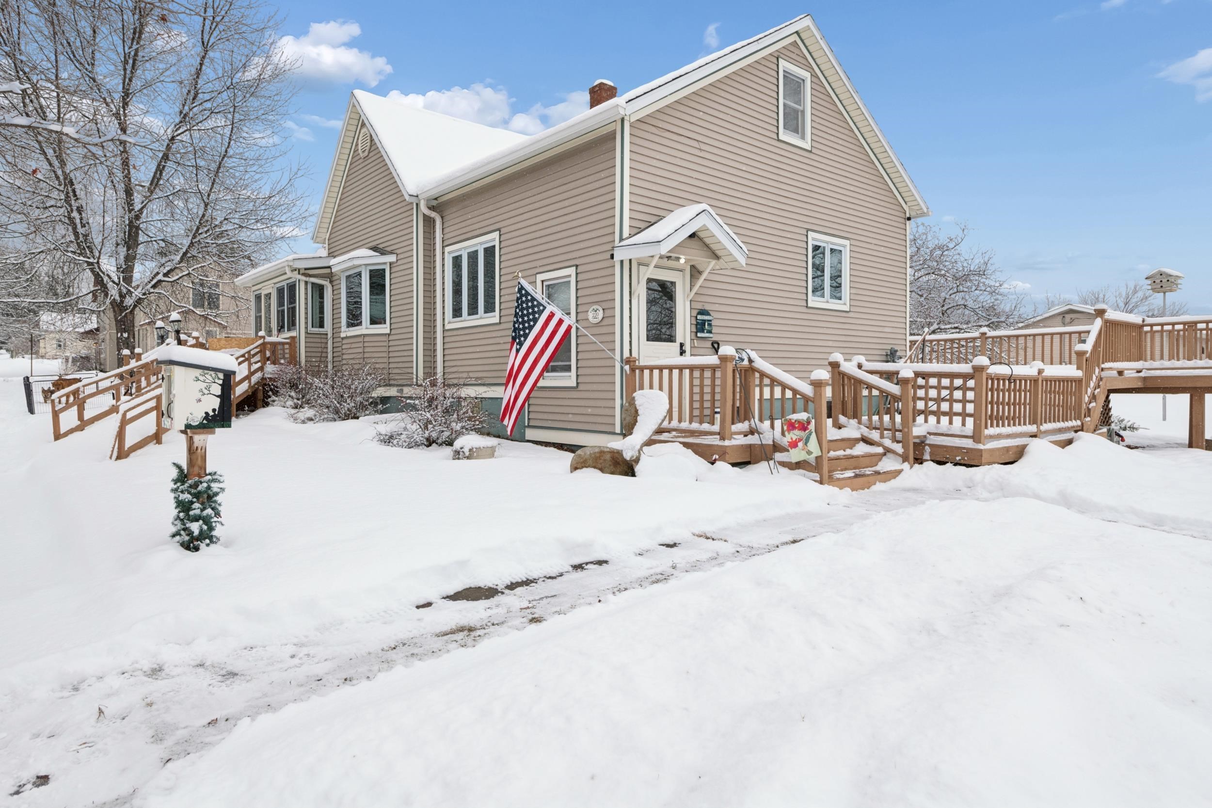 220 5th Avenue West Washburn, WI 54891 - Photo 30 of 38 Snow covered rear of property with a chimney and a wooden deck