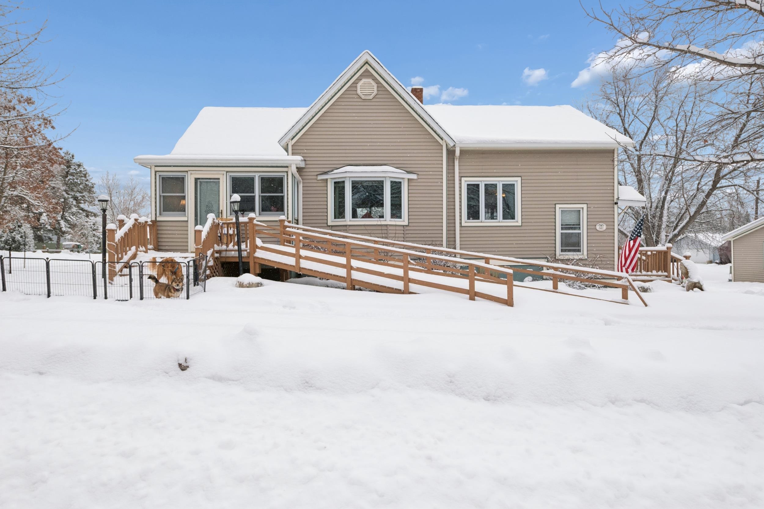 220 5th Avenue West Washburn, WI 54891 - Photo 33 of 38 Snow covered house with a wooden deck and a chimney