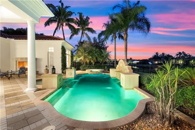 a view of a swimming pool with a table and chairs