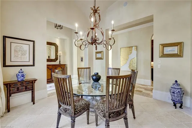a view of a dining room with furniture and chandelier