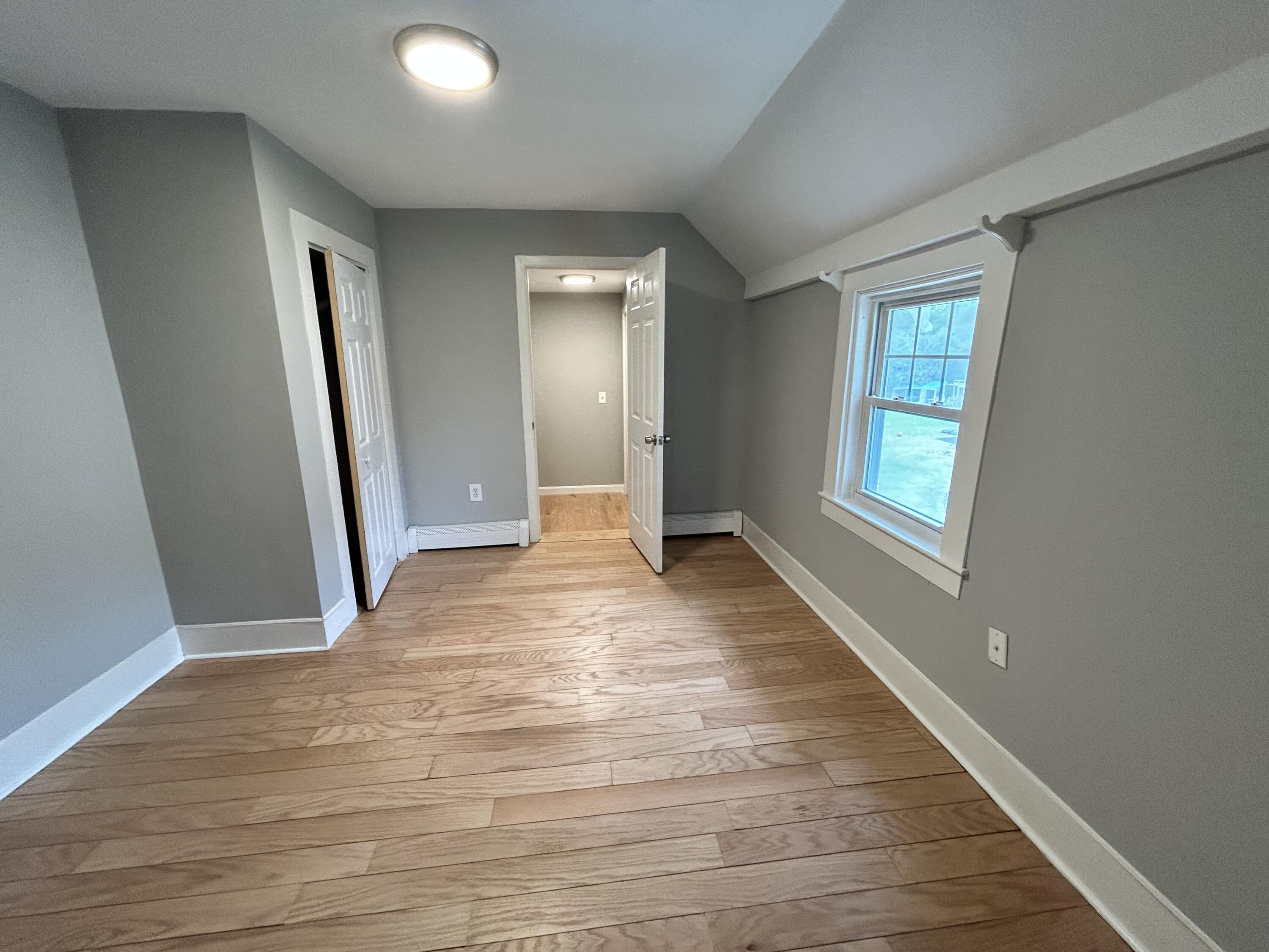 83 Marion Road Wareham, MA 02571 - Photo 13 of 32 an empty room with wooden floor and windows
