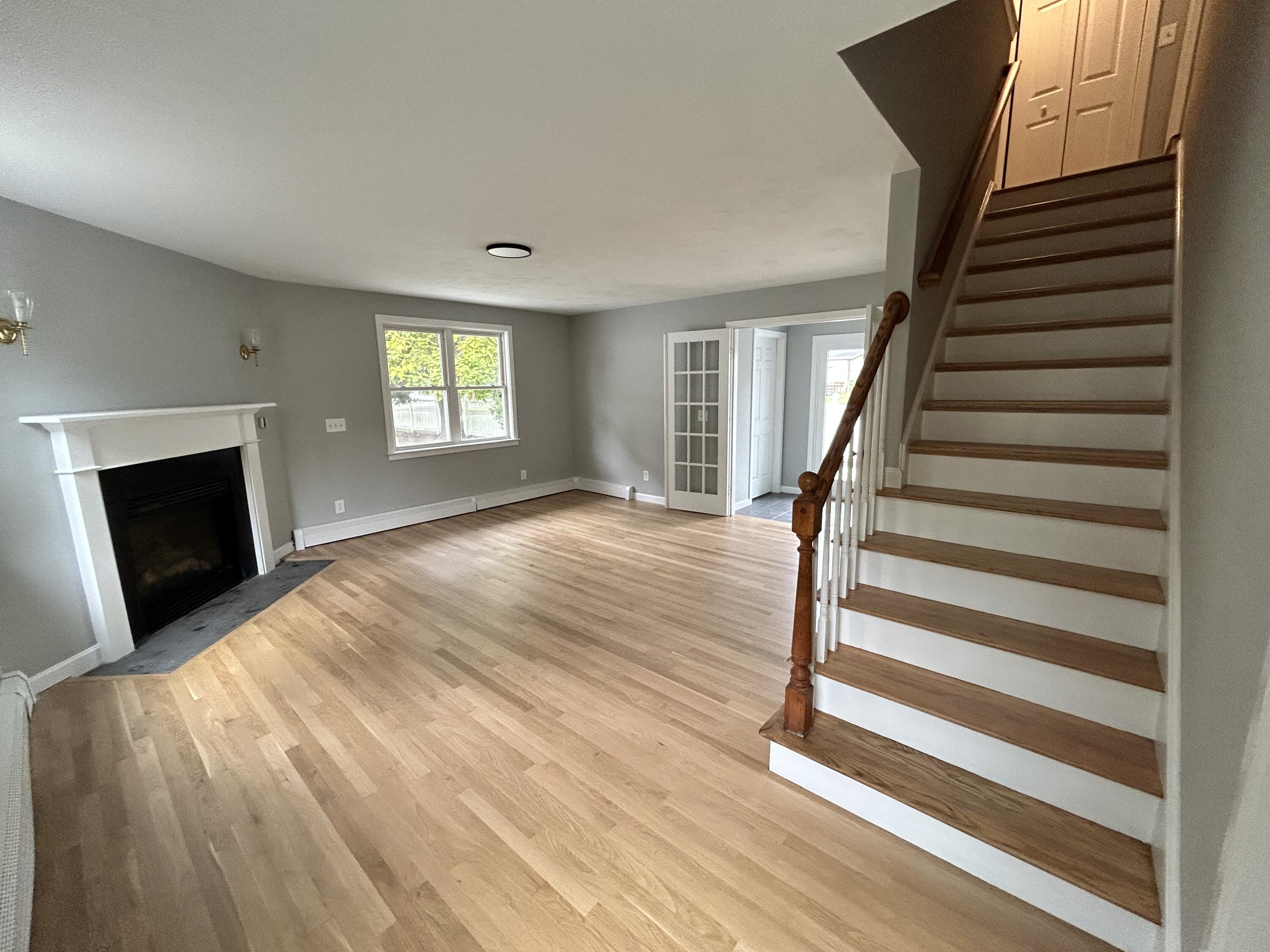 83 Marion Road Wareham, MA 02571 - Photo 15 of 32 a view of a livingroom with wooden floor and staircase
