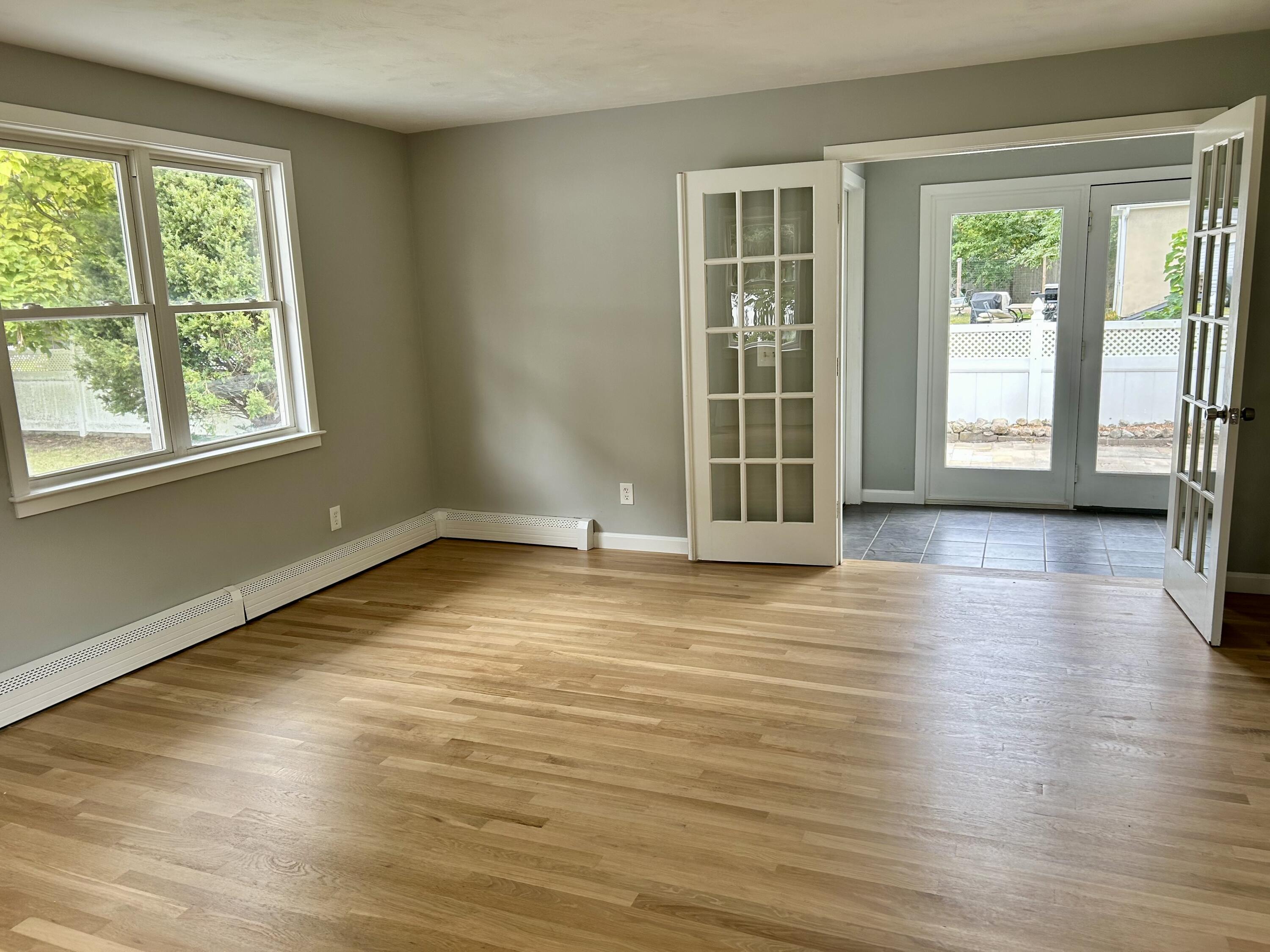 83 Marion Road Wareham, MA 02571 - Photo 17 of 32 a view of an empty room with wooden floor and a window