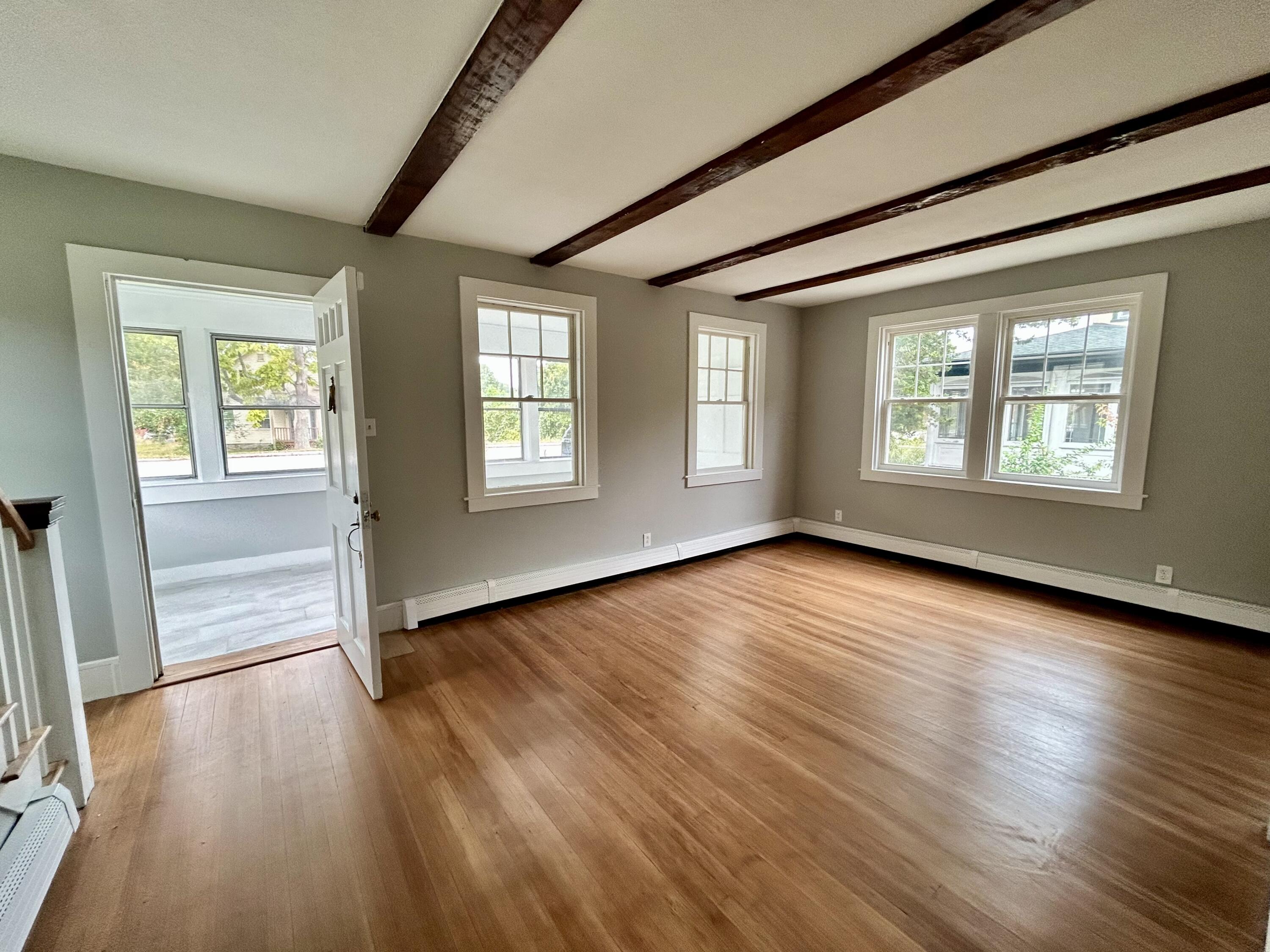 83 Marion Road Wareham, MA 02571 - Photo 4 of 32 an empty room with wooden floor and windows