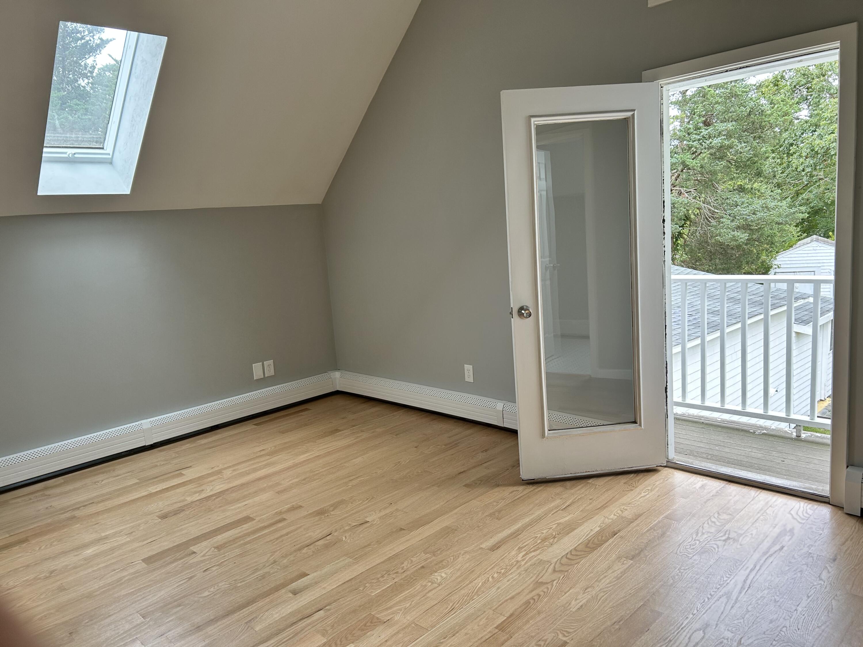 83 Marion Road Wareham, MA 02571 - Photo 7 of 32 an empty room with wooden floor and windows
