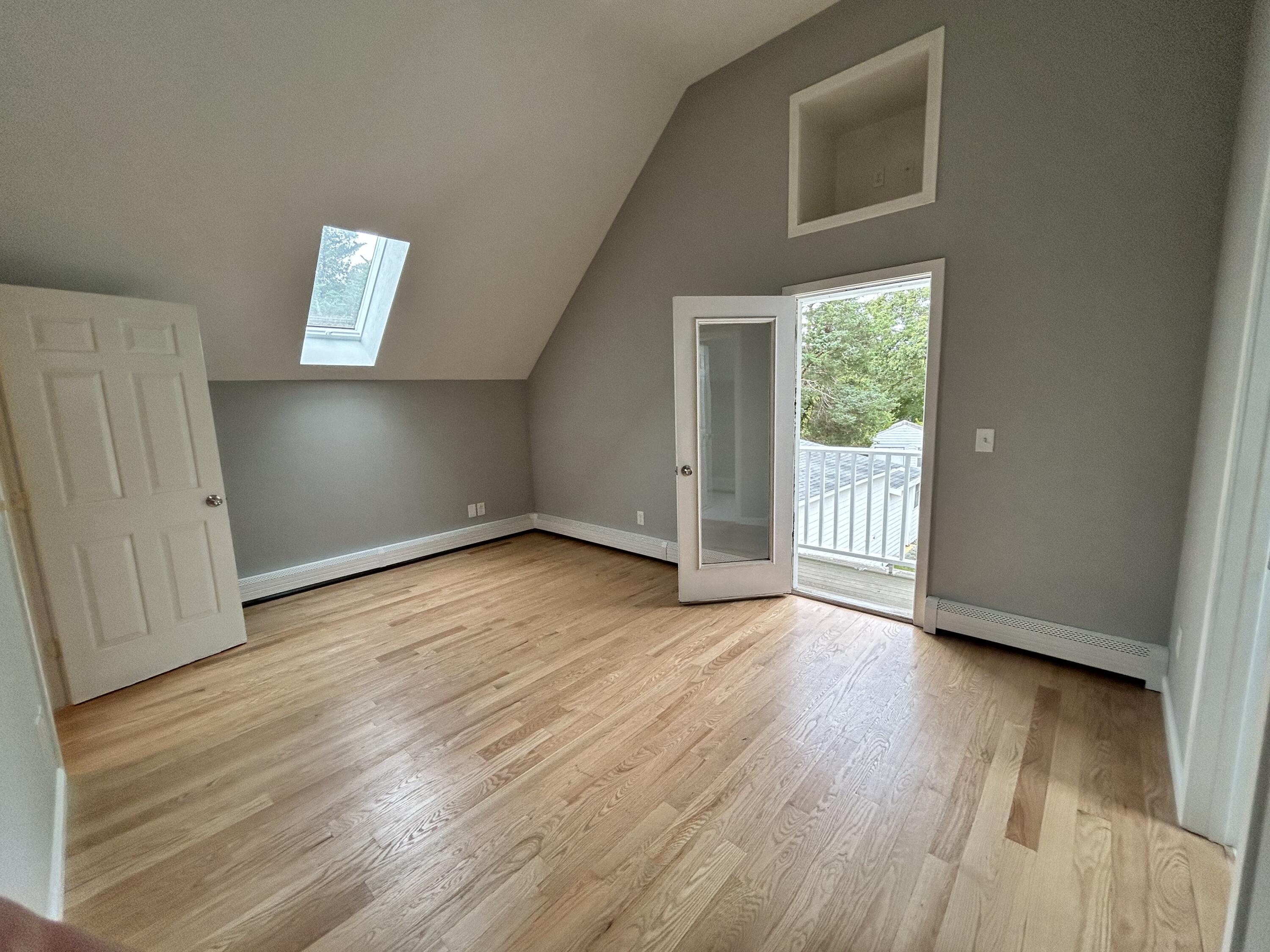83 Marion Road Wareham, MA 02571 - Photo 8 of 32 a view of an empty room with wooden floor and a window
