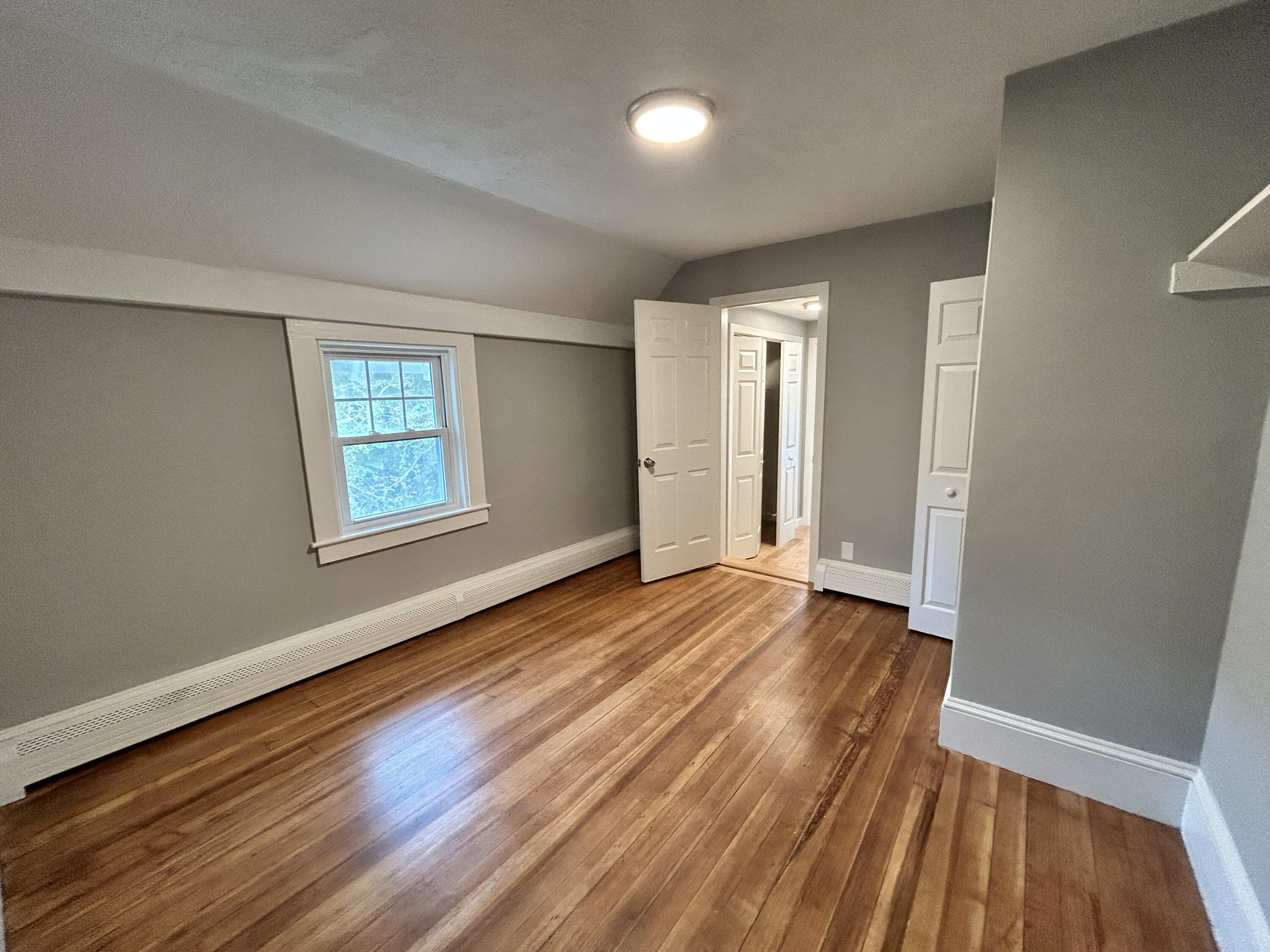 83 Marion Road Wareham, MA 02571 - Photo 10 of 32 an empty room with wooden floor and windows