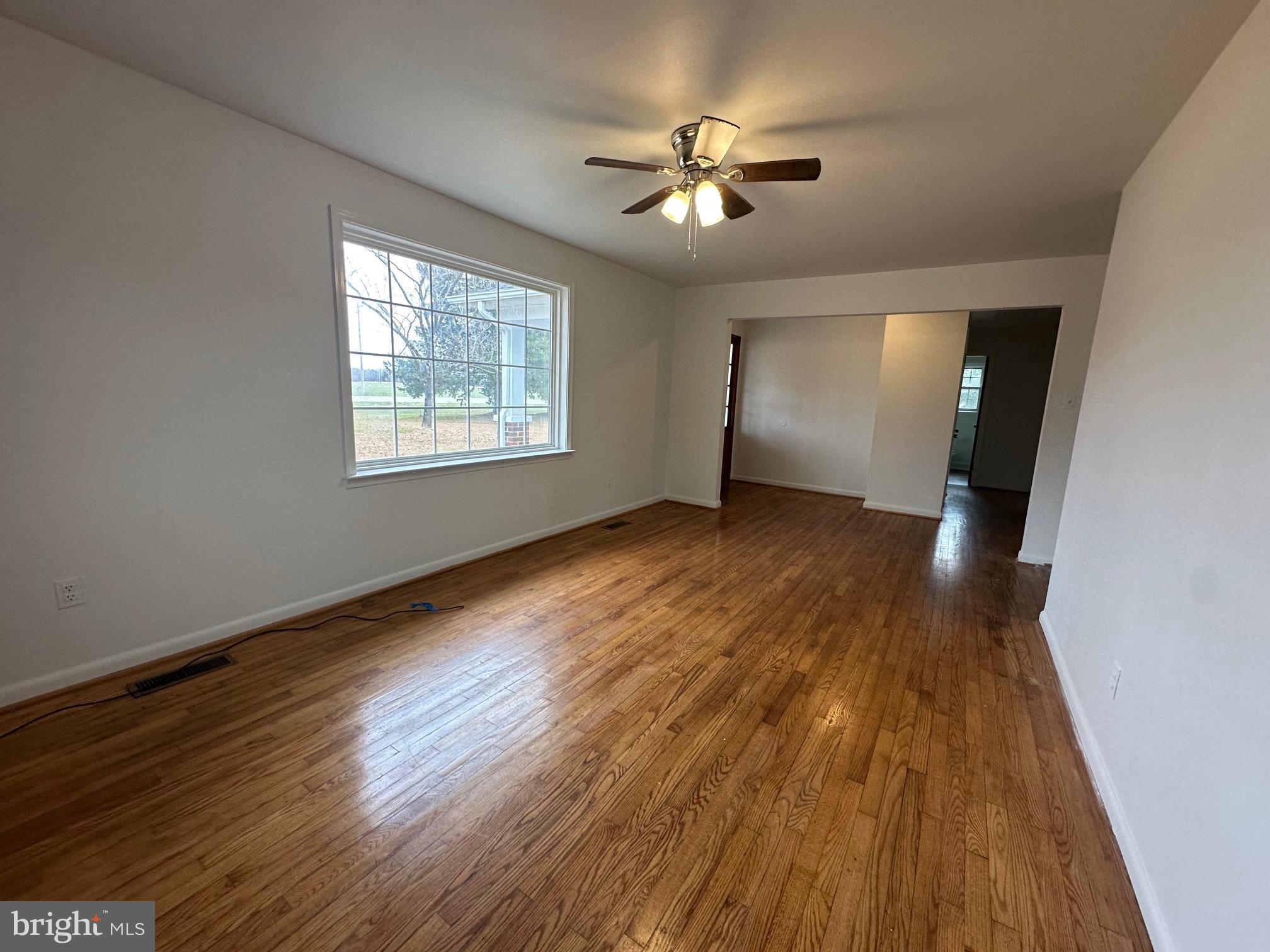 14835 Rock Point Road Newburg, MD 20664 - Photo 6 of 13 a view of an empty room with wooden floor and a window