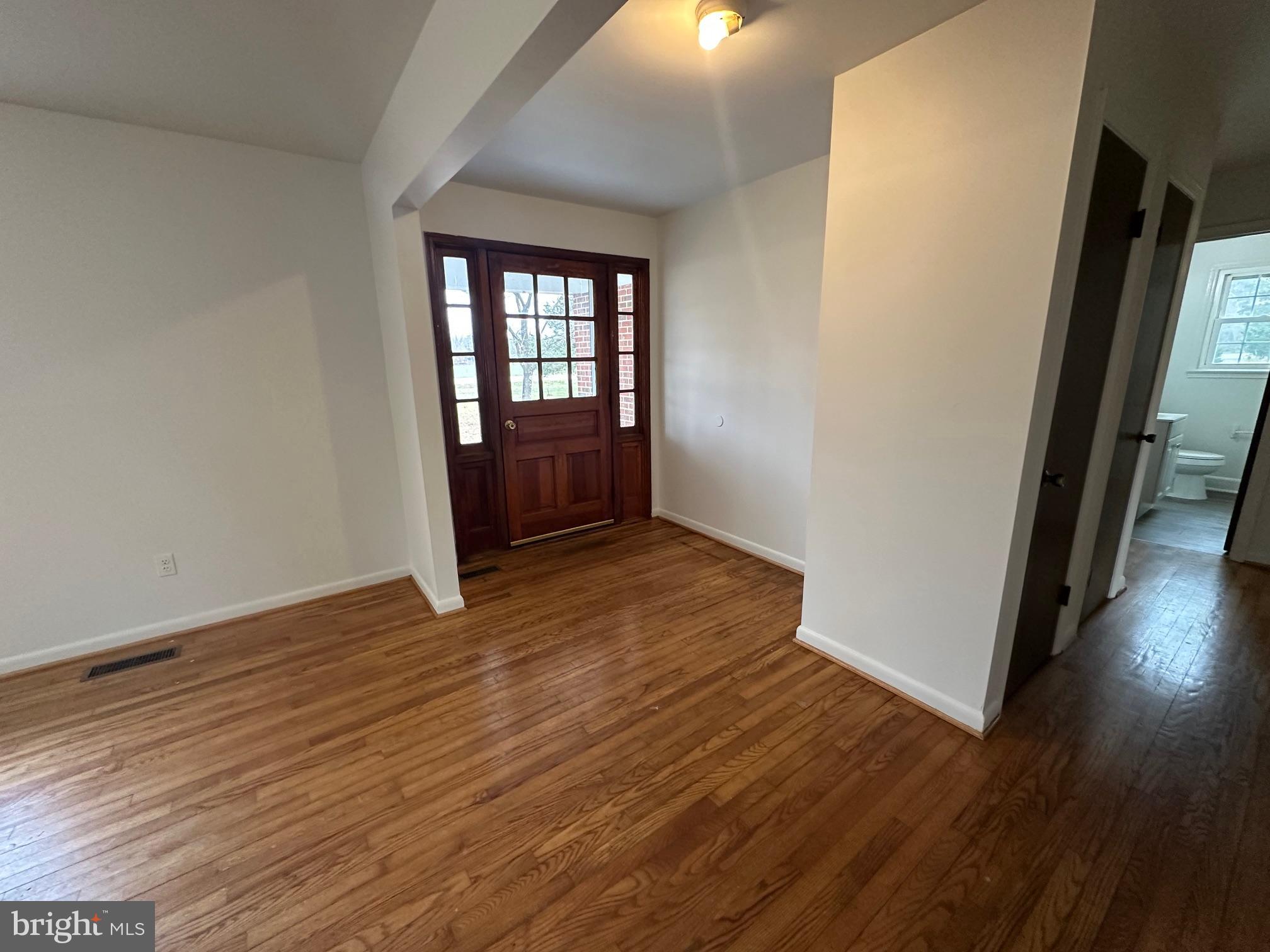 14835 Rock Point Road Newburg, MD 20664 - Photo 7 of 13 a view of an empty room with wooden floor and a window