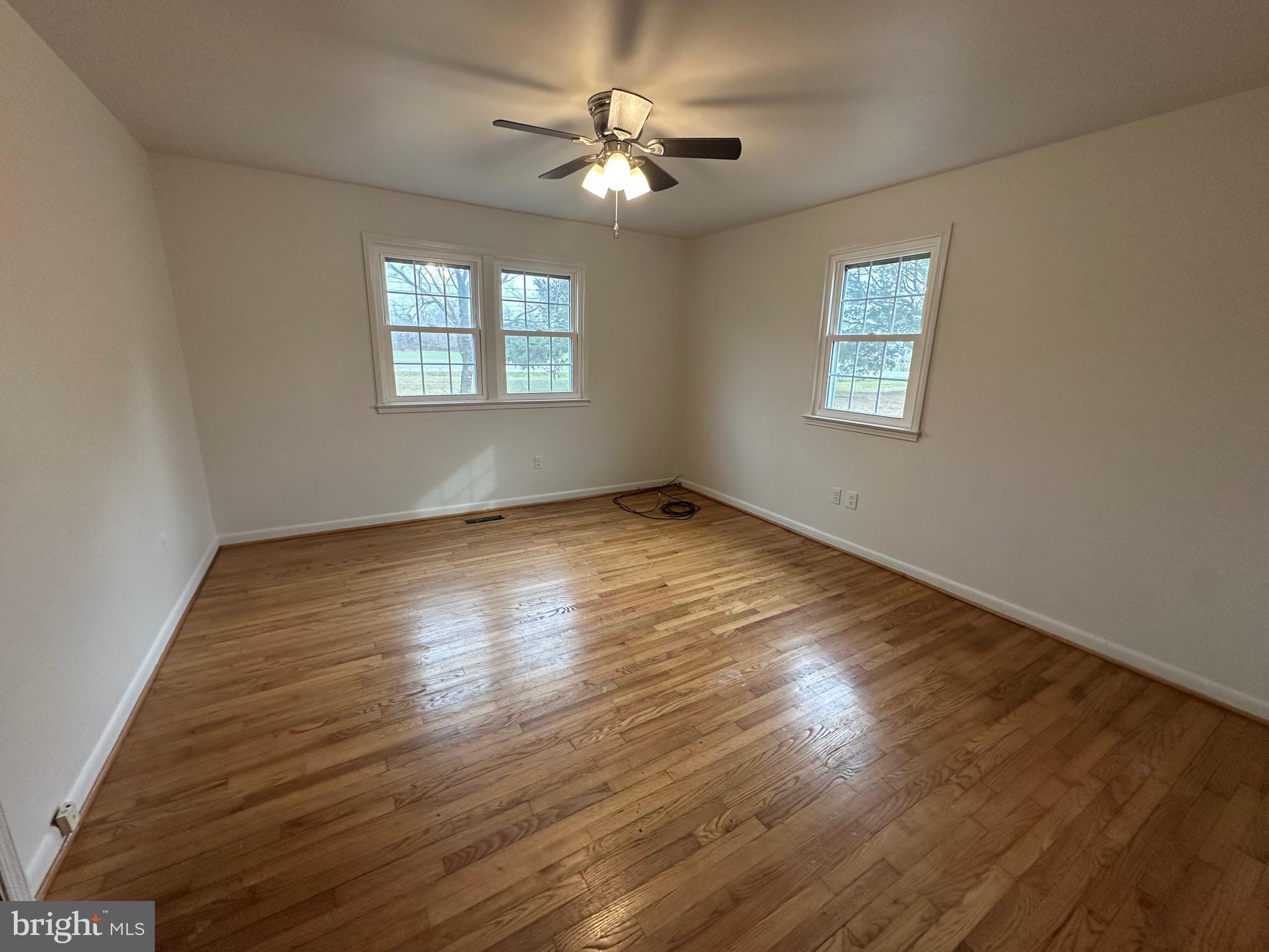 14835 Rock Point Road Newburg, MD 20664 - Photo 8 of 13 a view of an empty room with wooden floor and a window