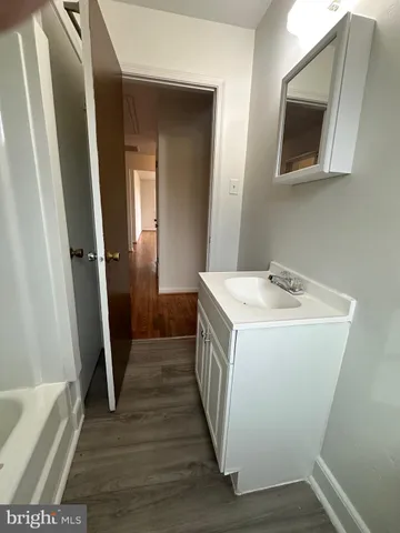 a view of bathroom with a sink and mirror