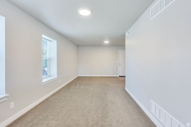 572 South 100 West, Unit E210 Springville, UT 84663 - Photo 17 of 35 Carpeted room featuring a white door, recessed lighting, and a window with blinds
