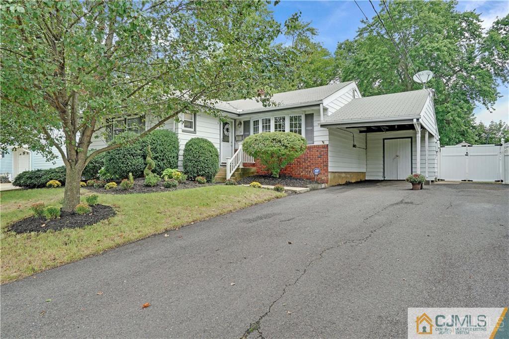 26 Mercer Road Old Bridge, NJ 08857 - Photo 1 of 23 a front view of a house with a yard and garage