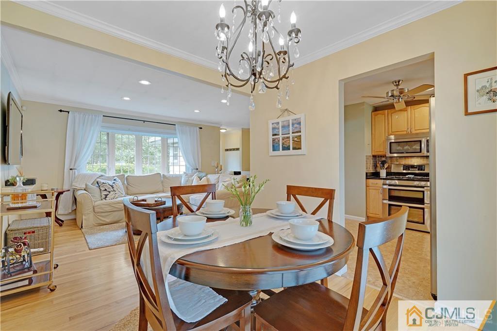 26 Mercer Road Old Bridge, NJ 08857 - Photo 7 of 23 a view of a dining room with furniture a chandelier and wooden floor