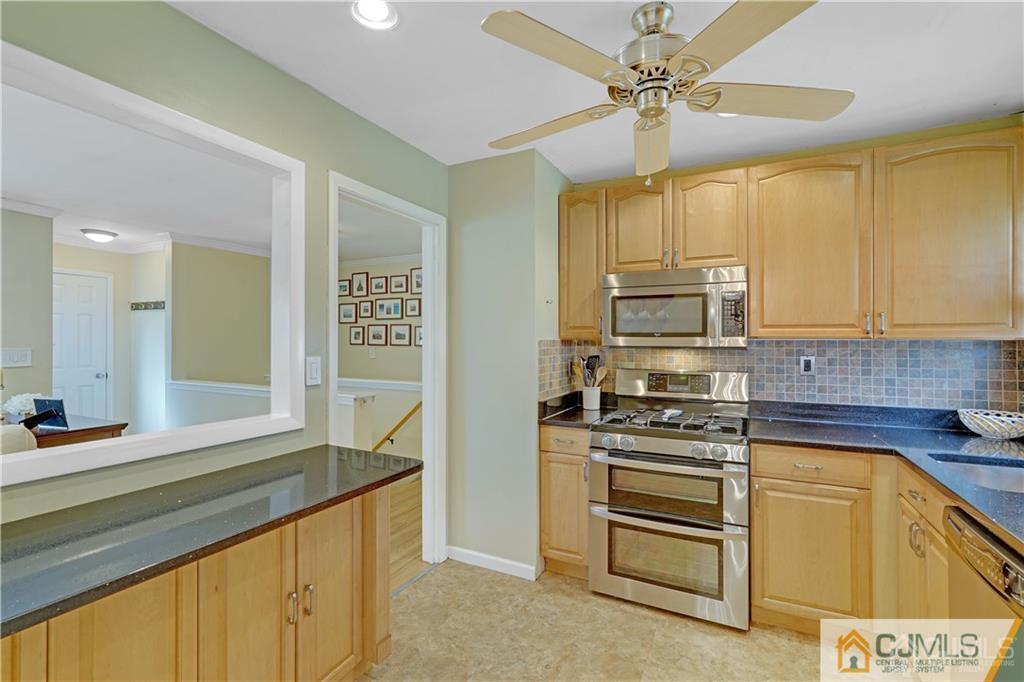 26 Mercer Road Old Bridge, NJ 08857 - Photo 8 of 23 a kitchen with kitchen island granite countertop a stove a sink and a refrigerator