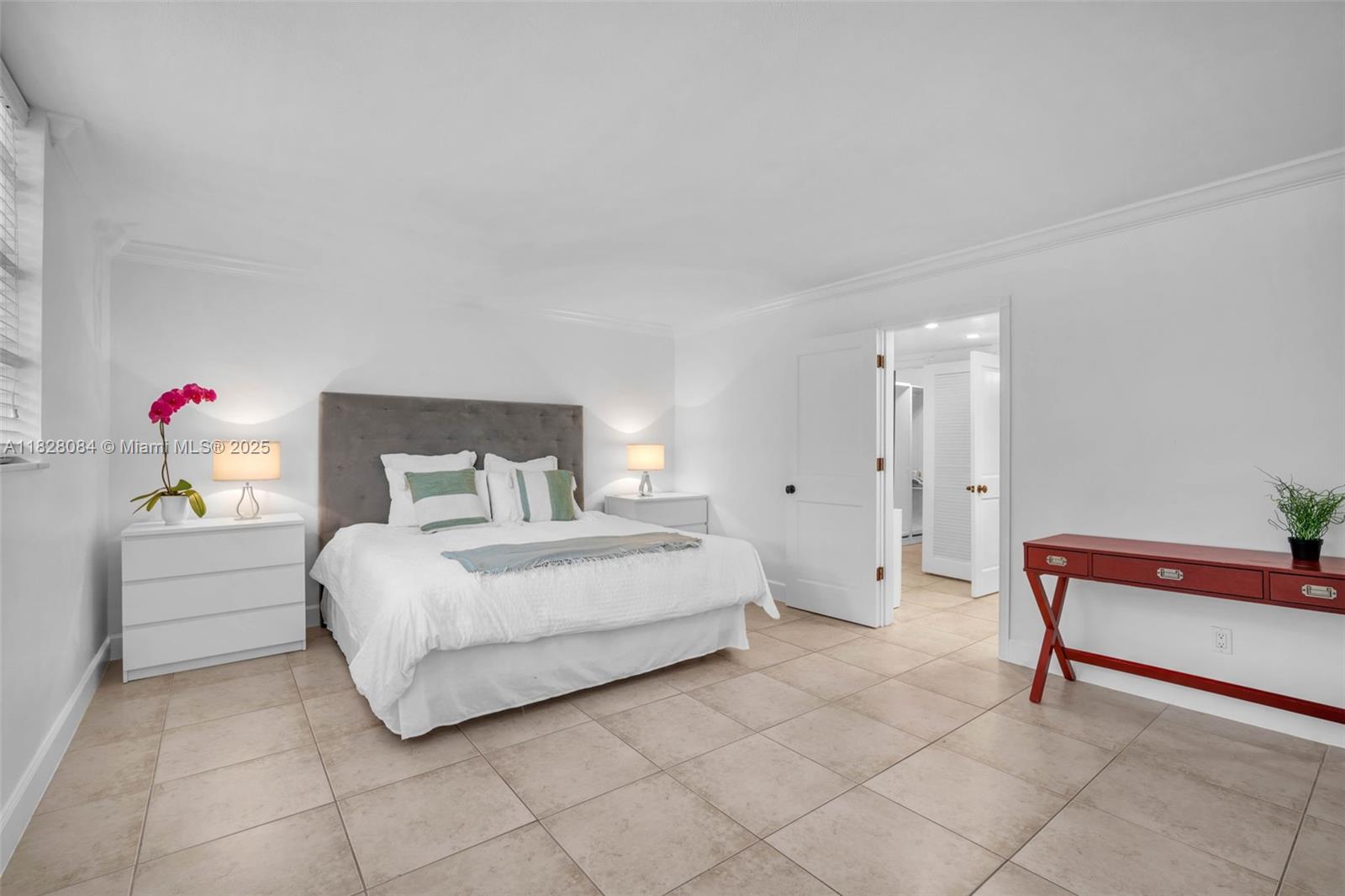 611 Ocean Drive, Unit 3E Key Biscayne, FL 33149 - Photo 11 of 30 a bedroom with a bed and dresser