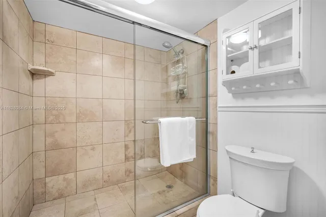 a white toilet sitting next to a bathroom sink