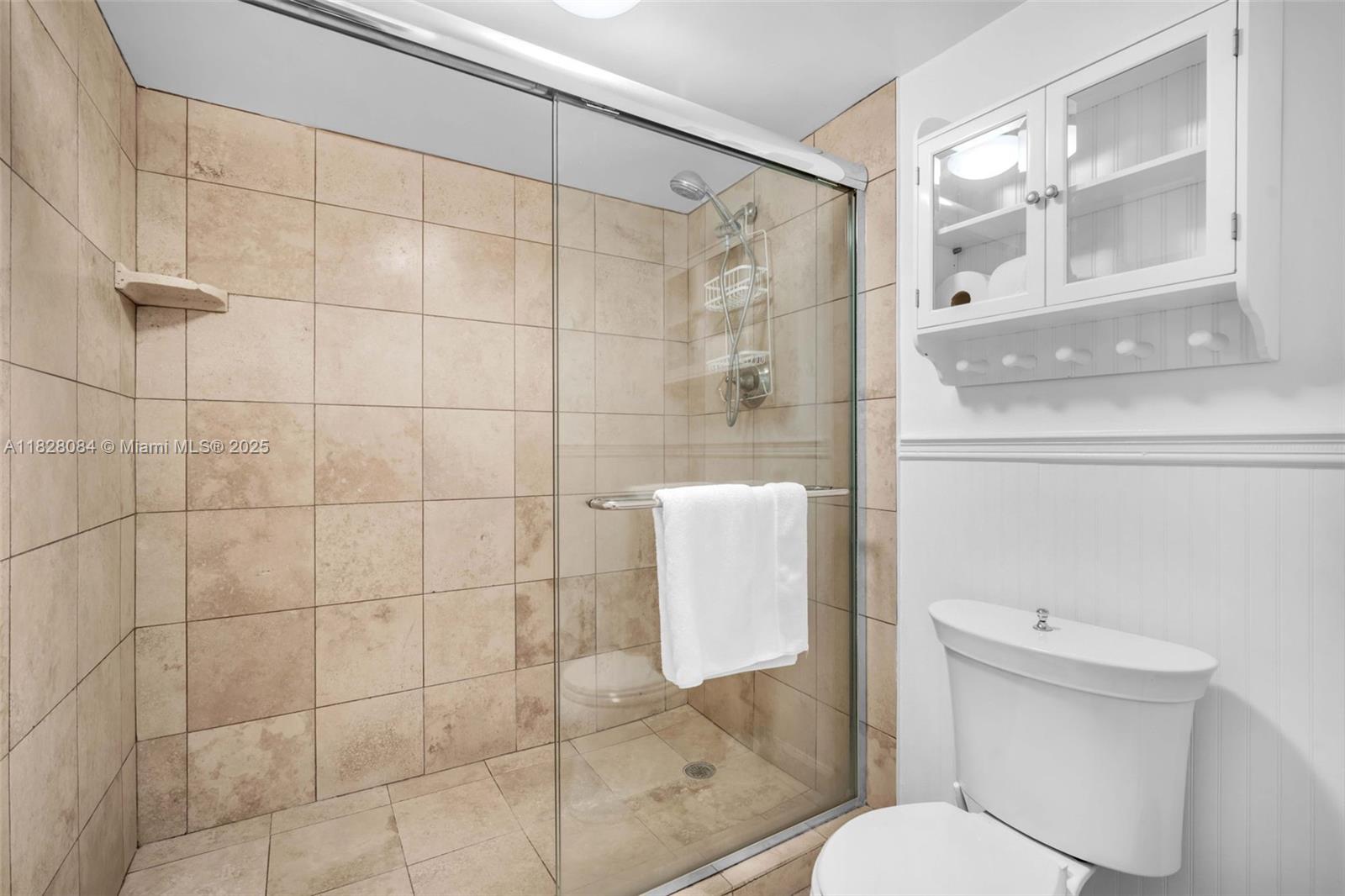 611 Ocean Drive, Unit 3E Key Biscayne, FL 33149 - Photo 13 of 30 a white toilet sitting next to a bathroom sink