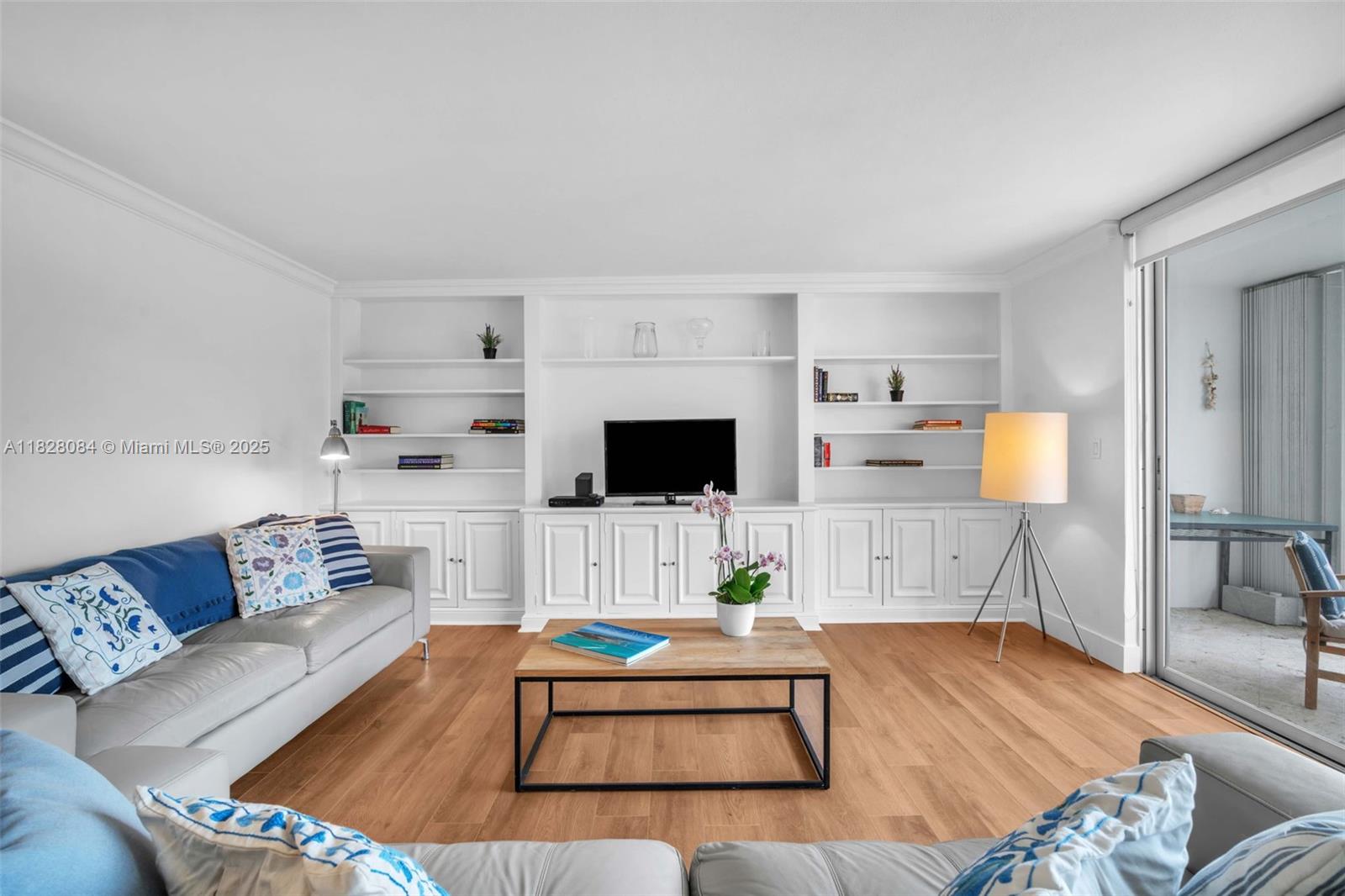 611 Ocean Drive, Unit 3E Key Biscayne, FL 33149 - Photo 5 of 30 a living room with furniture and a flat screen tv