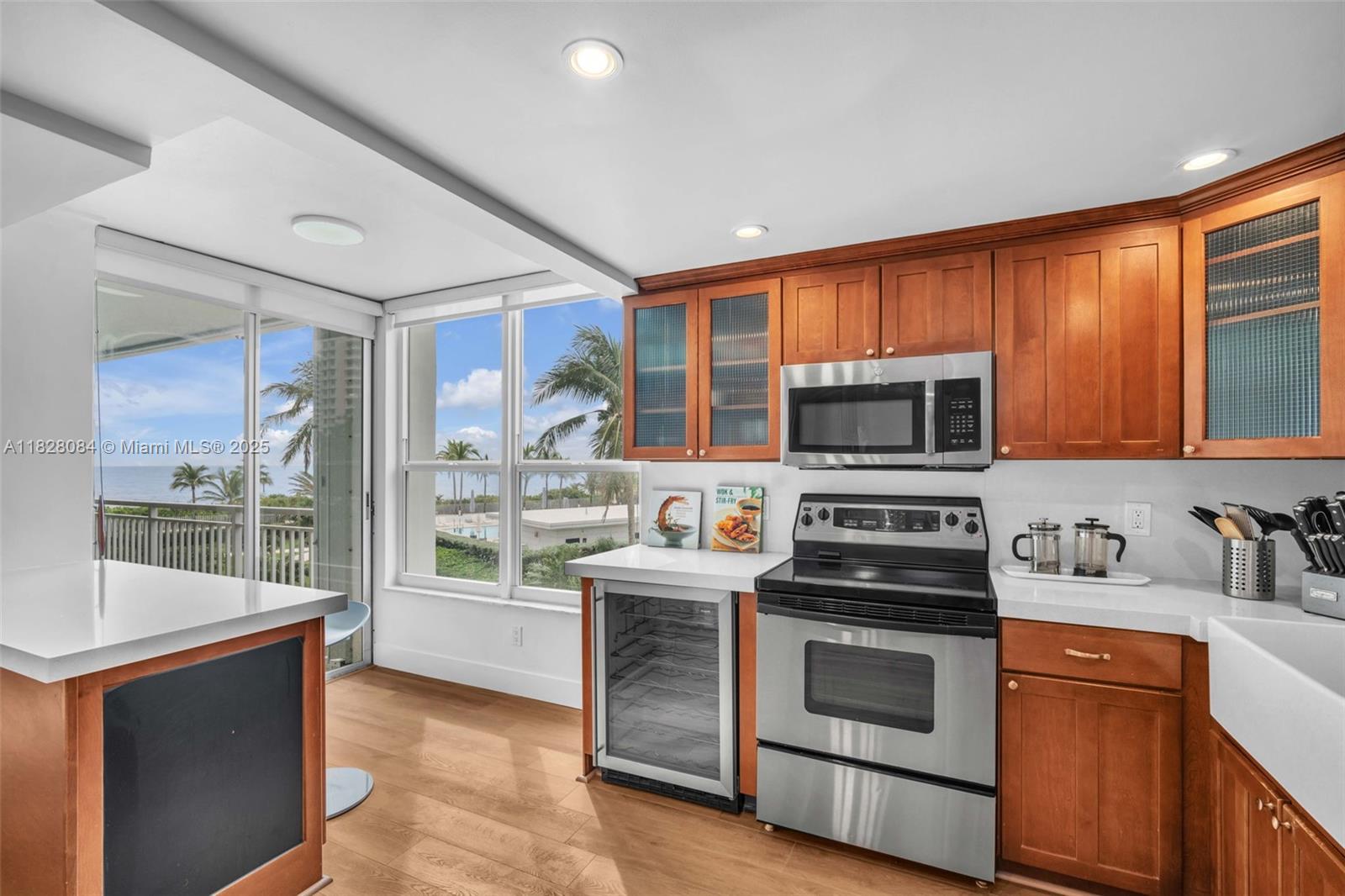 611 Ocean Drive, Unit 3E Key Biscayne, FL 33149 - Photo 7 of 30 a kitchen with stainless steel appliances a stove sink and microwave