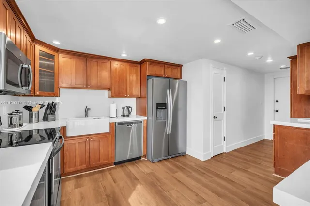 a kitchen with stainless steel appliances granite countertop a refrigerator sink and cabinets