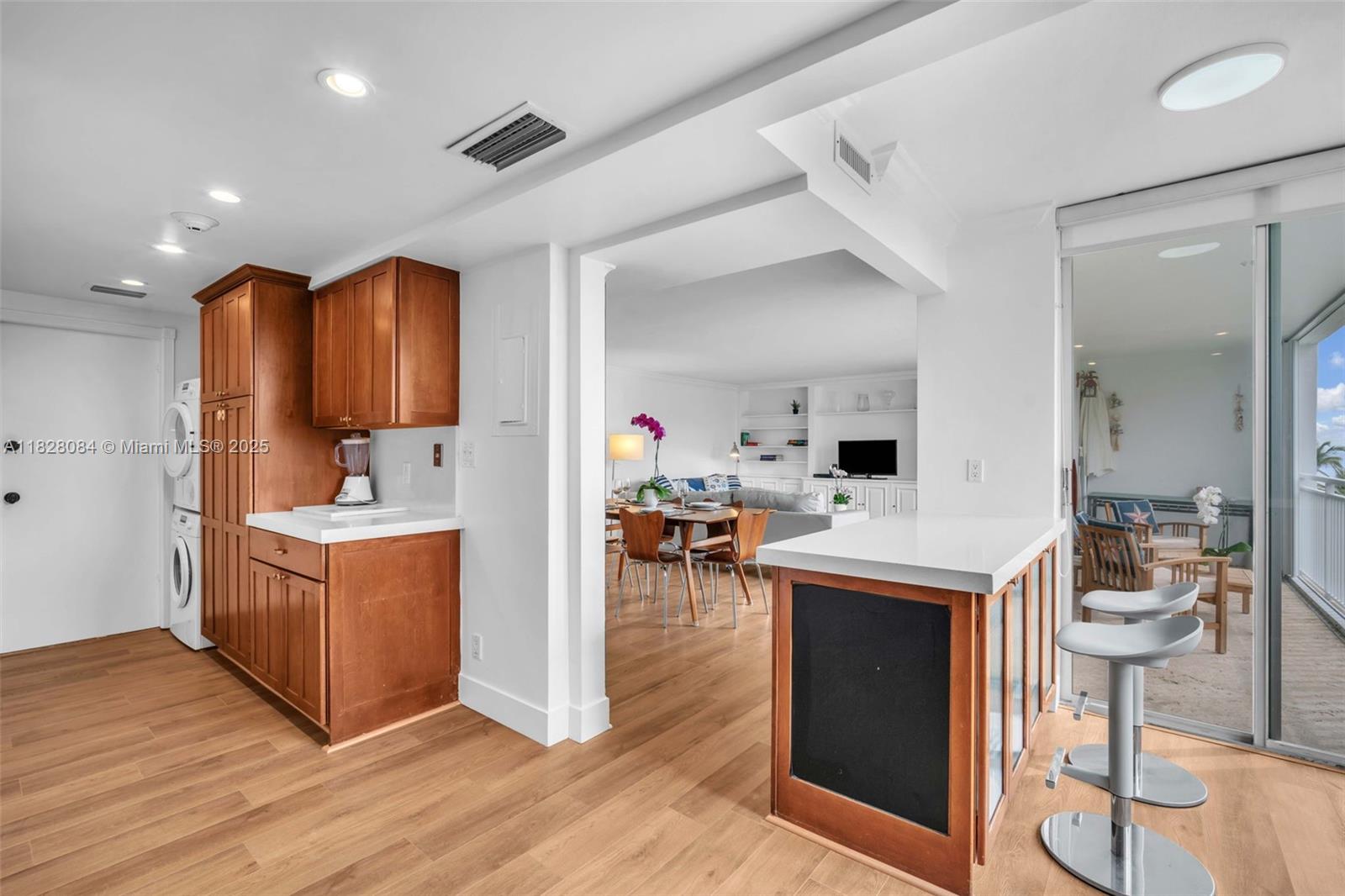611 Ocean Drive, Unit 3E Key Biscayne, FL 33149 - Photo 9 of 30 a kitchen with stainless steel appliances kitchen island wooden floors and wooden cabinets